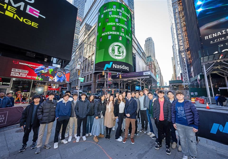 students in front of nasdaq sign